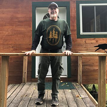 Craig Willis stands outside the front door of a house